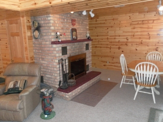 Family room on lower level with natural fireplace.